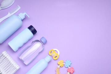 Flat lay composition with baby care products and accessories on lilac background, space for text