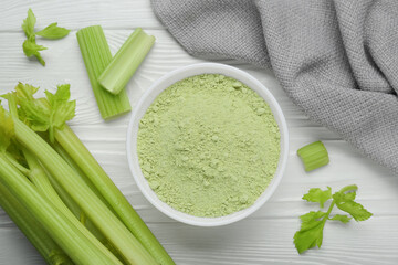 Natural celery powder in bowl and fresh stalks on white wooden table, flat lay © New Africa