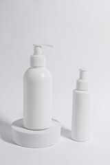 Fototapeta na wymiar Bottles with cosmetic products on white background