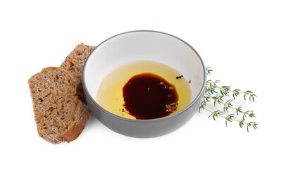 Bowl of organic balsamic vinegar with oil, spices and bread isolated on white