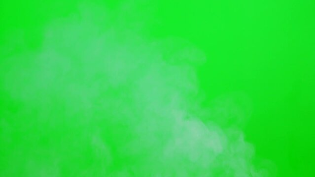 Slow motion smoke flowing on green screen background