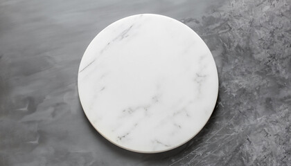 White empty marble texture round board on grey background. Top view. Copy space.