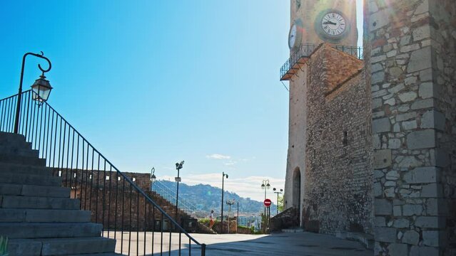 Clock and bell tower of Church of Notre Dame D'esperance in Cannes. Famous landmark at a resort town on the French Riviera, Cote D'Azur.