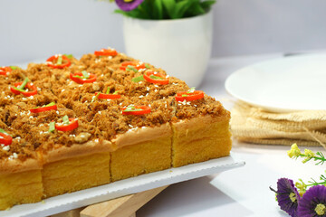 beef floss Sponge Cake with a sprinkling of sesame, green onions, and pieces of red chili on a...