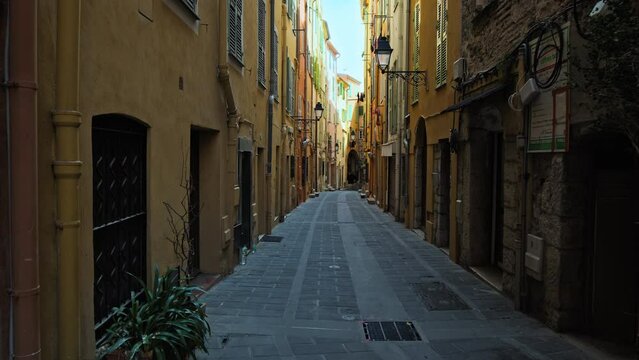 Cinematic view of a narrow street in Menton, France. Stunning French Riviera with unique colorful houses in Menton.