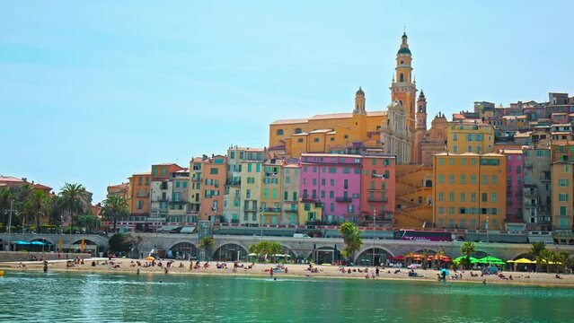 Panoramic detailed scenic view of colorful houses in Provence village Menton, France.  Tourists enjoy vacation with colorful houses and sand beach in the historical Old in Cote d'Azur, France.