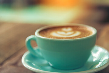 Latte art coffee cup with milk on wooden table. Espresso shot make latte art hot coffee cup. Cappuccino with milk in italian coffee shop cafe. Brown hot caffeine beverage in cafeteria with copy space