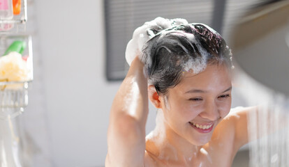 Asian girl having fun while showering She's washed her hair.