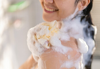 female Asian taking joy in the shower and using soap She feels at rest.