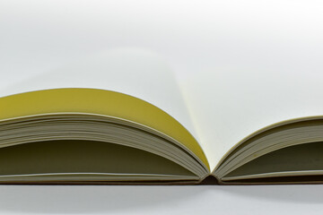 top view image of open notebook with blank page, spotted paper texture isolated on white background