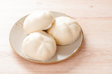 Fototapeta na wymiar Baozi or Chinese Steamed Buns is a type of yeast-leavened filled bun in various Chinese cuisines.