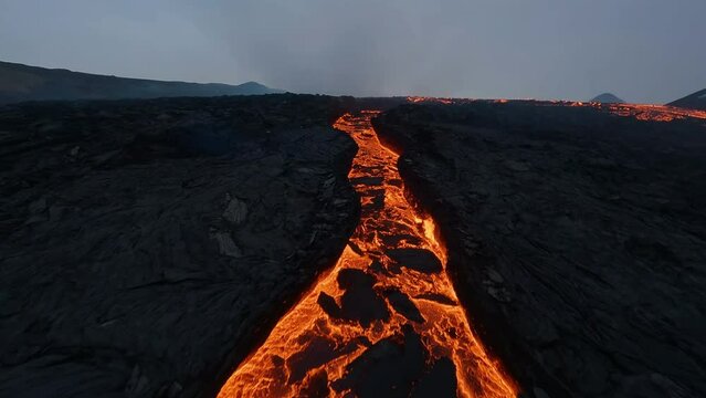 Flying low over lava falls and over a glowing magma cone - Cinematic FPV shot