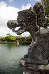 View at the pond and statue at Balinese Royal Water Palace Tirta Gangga, former kings palace in Karangasem, Bali, Indonesia