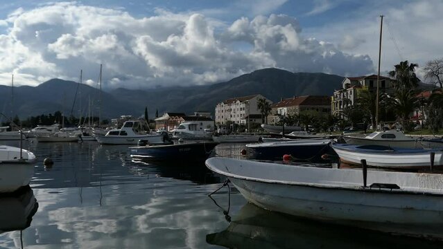 Small boats docked in marina, promenade, mountain view, Tivat, Montenegro