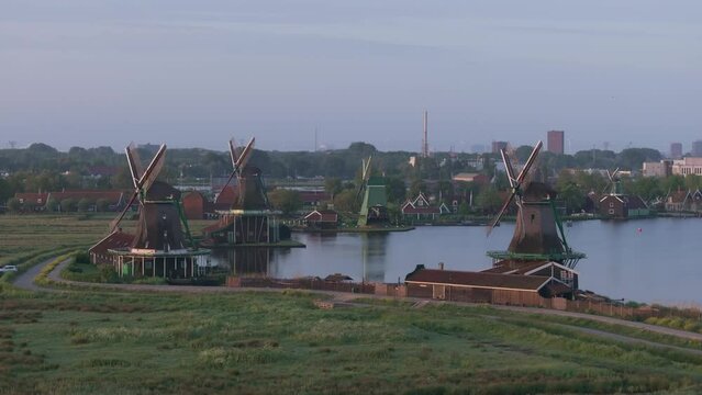 Wide shot of Zaanse schans windmills Zaandam with soft morning light, aerial