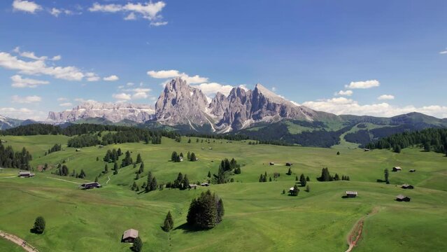 Aerial panorama of Alpe di Siusi alpine plateau with Dolomites mountain background