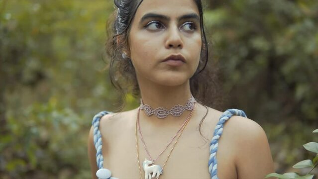 Close up shot of a young Indian mother with a sharp look