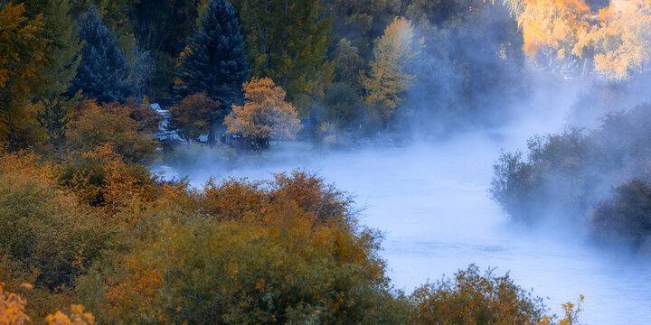 Provo river and canyon filled with morning fog in Utah, surrounded with beautiful fall foliage.
