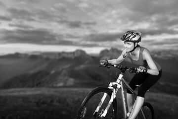 Fototapeta na wymiar Athlete cyclists ride on black and white background