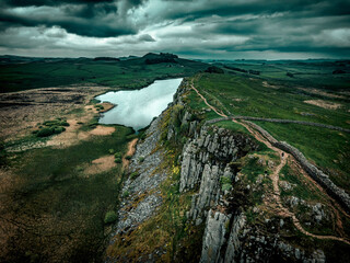 The aerial view of the the Hadrian's Wall in the Northumberland National Park under the storm clouds