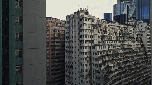 Aerial of an old apartment complex called Yick Fat on Quarry Bay, Hong Kong, China. Known also as Monster Building because it was featured in a Transformers movie. Drone truck up shot