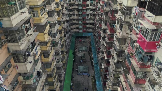 Aerial of an old apartment complex called Yick Fat on Quarry Bay, Hong Kong, China. Known also as Monster Building because it was featured in a Transformers movie. Drone truck up shot