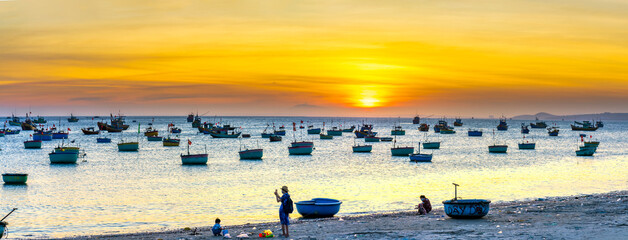 Mui Ne fishing village in sunset sky with hundreds of boats anchored to avoid storms, this is a...
