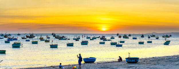 Mui Ne fishing village in sunset sky with hundreds of boats anchored to avoid storms, this is a beautiful bay in central Vietnam