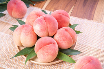 Pink Peach on wooden Table,  Peach with leaf on wooden background.