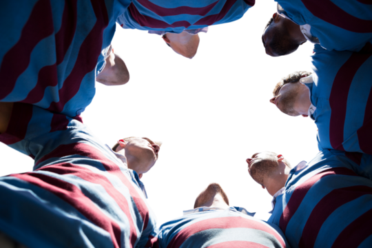 Digital png photo of diverse male rugby players in circle with copy space on transparent background