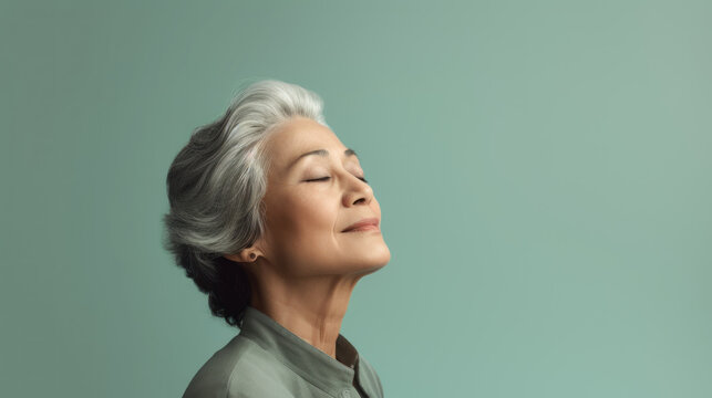 Old Woman Standing With Eyes Closed On Pastel Green Color Background