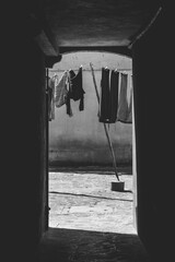 Clothes hanging on wire to dry outside, in Venice. Black and white photography