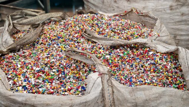 Sack of sorted multicoloured plastic garbage at waste recycling factory