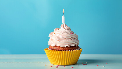 Delicious birthday cupcake on table on light blue background