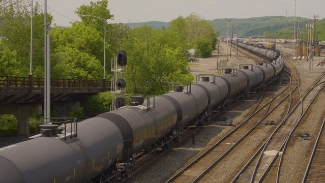 a long string of tanker cars travel the railroad in the hills of Pennsylvania