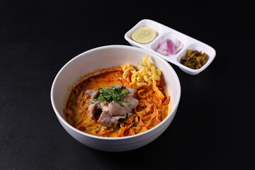 Khao Soi Thai Curry soup isolated in black background