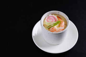 Japanese Traditional food Eggs Custard Chawanmushi isolated in black background