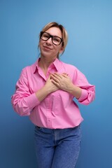 portrait of a young successful blond careerist leader woman in a pink blouse and glasses