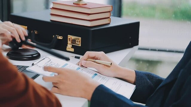 Business and lawyers discussing contract papers with brass scale on desk in office. Law, legal services, advice, justice and law concept picture with film grain effect