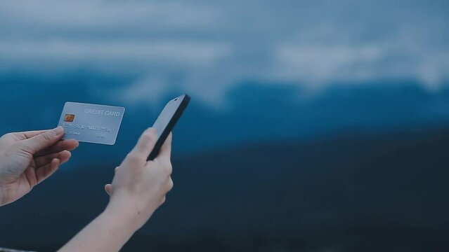 .Young woman freelancer traveler working online using laptop and enjoying the beautiful nature landscape with mountain view at sunrise