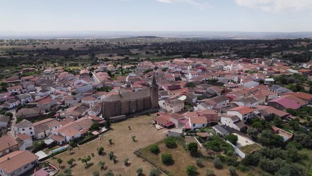 Aerial over Tejeda de Tietar's unique San Miguel Arc&aacute;ngel church, Spain