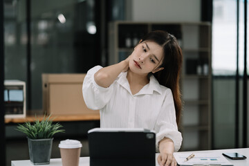 Women sitting at home office workplace gesture neck pain office syndrome concept.