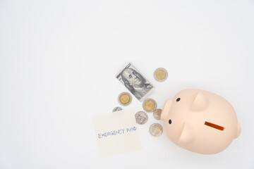 concept of emergency savings fund. A piggy bank with dollar and coins. piggy bank for saving emergency money.Saving for emergency concept. isolated background.