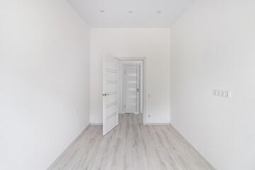 Empty renovated room with door in light colors