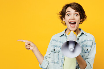 Young happy woman she wear green t-shirt denim shirt casual clothes hold in hand megaphone scream...