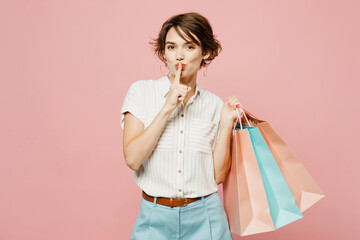 Young secret woman wear casual clothes hold shopping paper package bags say hush be quiet with...