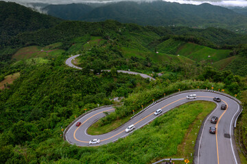 Aerial view of a winding mountain road in a beautiful tropical forest.