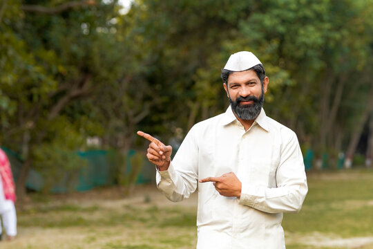 Indian or marathi man in traditional wear and giving expression at park.