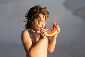 Happy child on the sea with watermelon. Funny child eat watermelon. Kid relaxing on summer sea beach. Kid with summer fruits in pool. Summer vacation with kids. Child with a piece of watermelon.