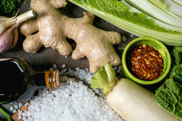 Ingredients for kimchi. Fresh vegetables, traditional Korean food in top view on wooden table copy space.